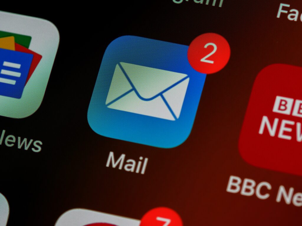 Part of a screenshot showing the email app on an iPhone. There is a badge on the icon showing 2 unread messages.
